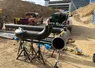 Large metal pipes and fittings staged at a commercial construction site
